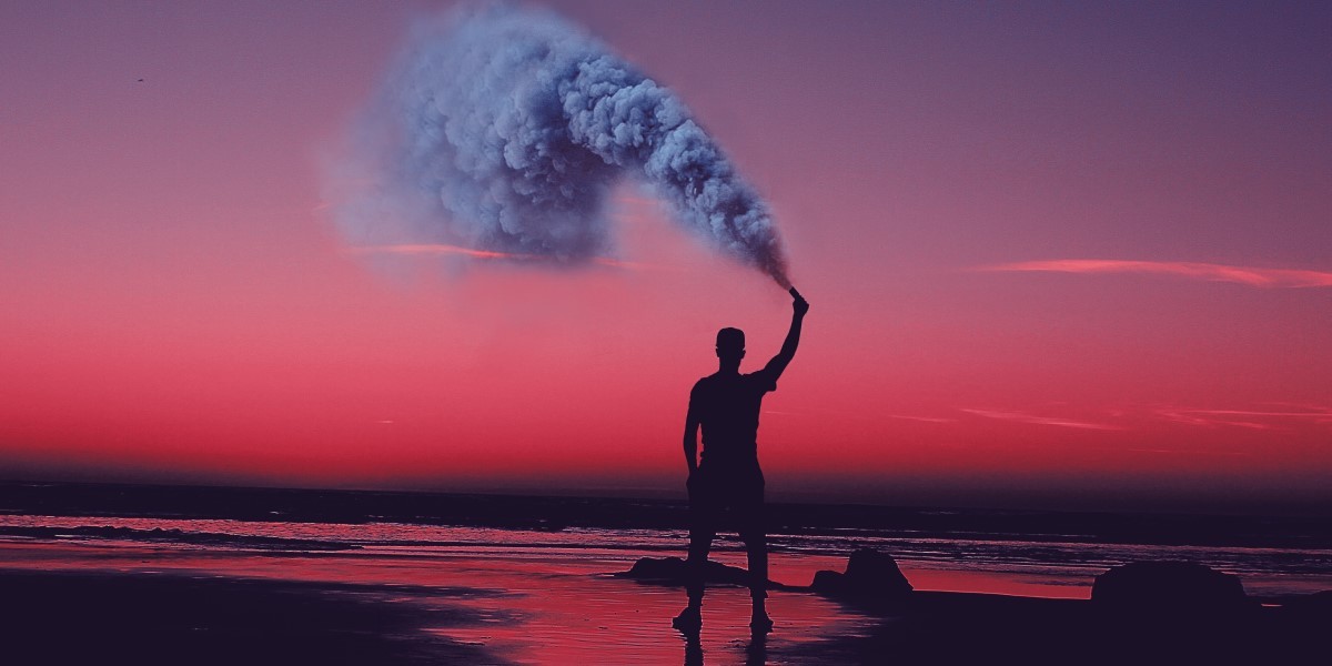 A man sprays gas on a beach