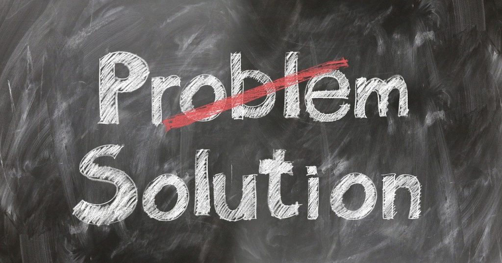a chalkboard with problem crossed through and solution not crossed through 